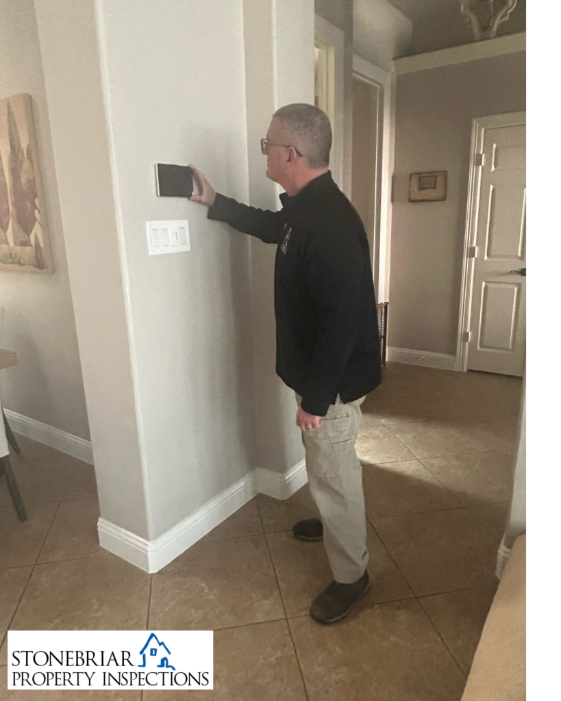 Stonebriar Property Inspections inspector inspecting thermostat