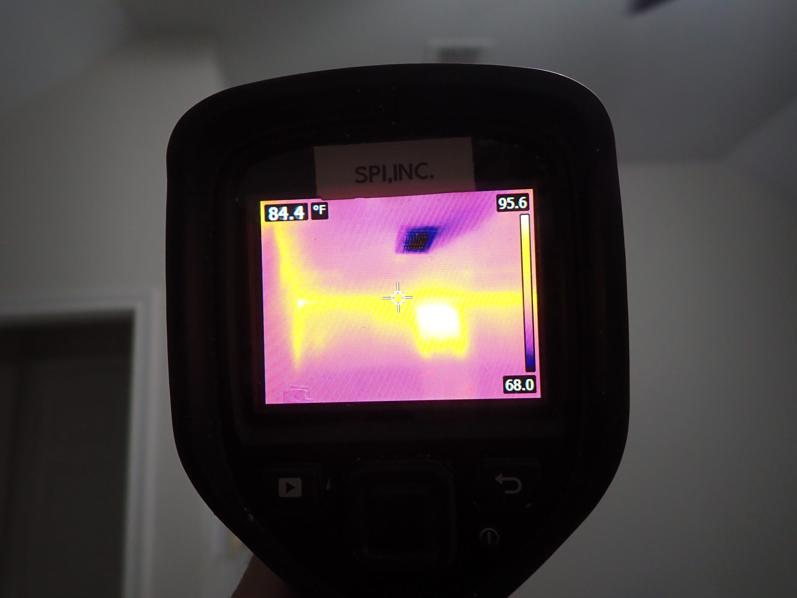 Infrared thermal camera image showing a distinct cool rectangular temperature anomaly on an interior wall during a North Texas home inspection