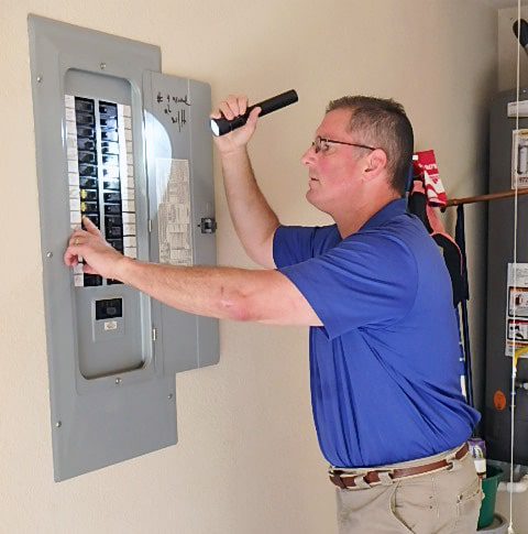 home inspector inspecting electrical panel